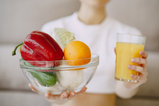 nutricionista mostrando jugo tazon verduras